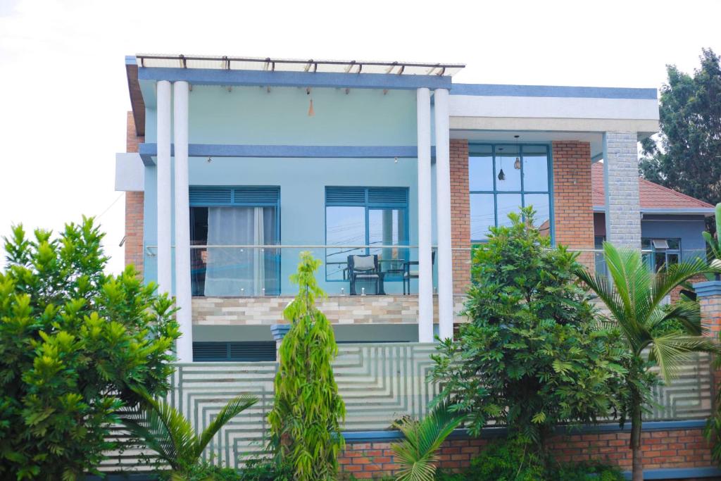 a house with a blue and white facade at Faraja Guest House in Kigali