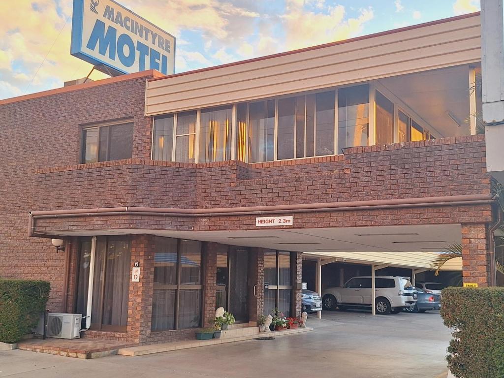 a large brick building with a motel sign on it at Macintyre Motor Inn in Goondiwindi