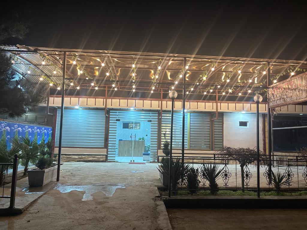 a building with lights on it at night at Old Bazar in Kogon