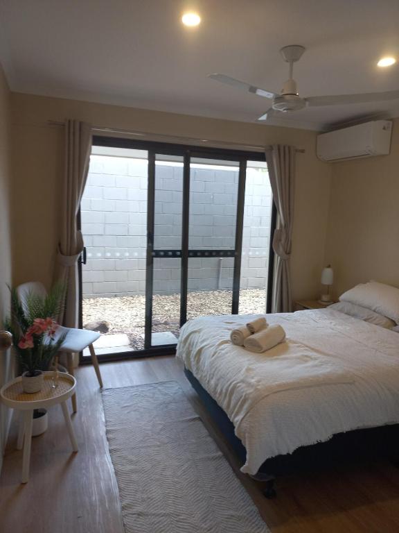 a bedroom with a large bed and a large window at Peaceful and private two bedroom unit in Alice Springs