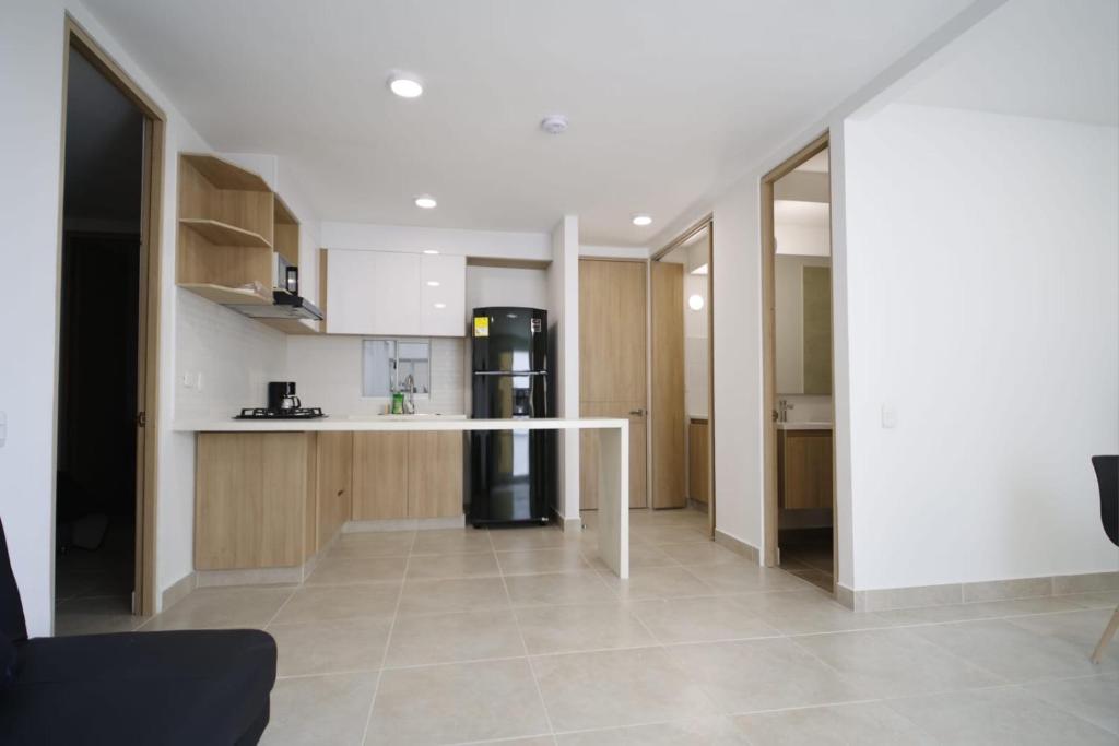 a kitchen with a counter and a refrigerator at Praseo in Serena del Mar