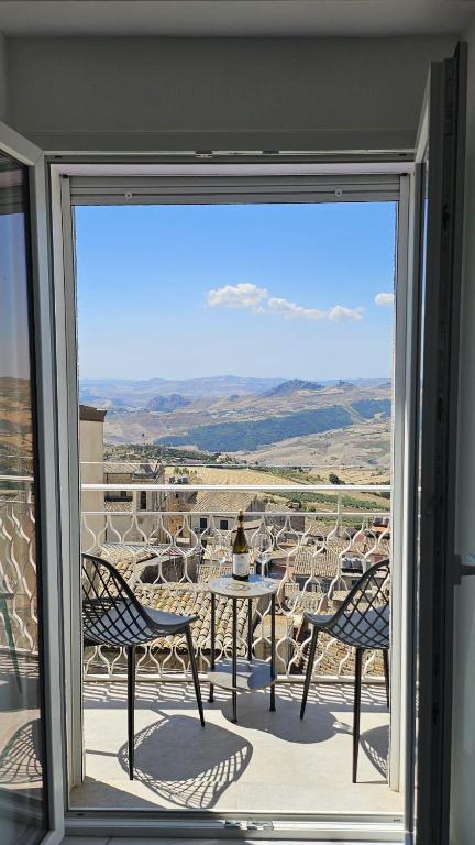 a view of a table and chairs from a window at Modern Hillside Retreat with Panoramic Views in Mussomeli