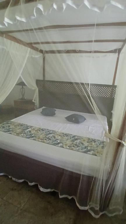 a bedroom with a bed with a canopy at Country Homes Srilanka in Mount Lavinia