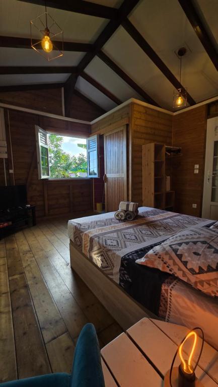 a bedroom with a large bed in a room at La Cachette in Le Marin