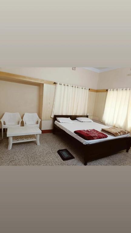 a bedroom with a large bed and a couch at Lotus palm in Deoghar