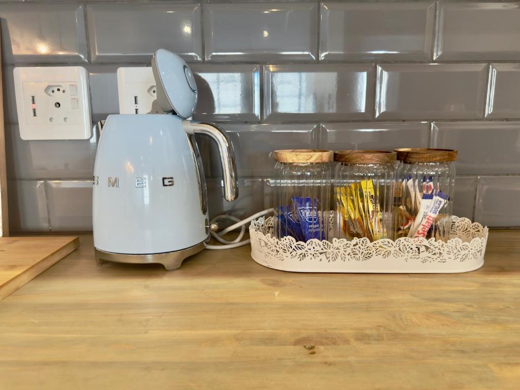 a toaster sitting on a counter next to a container of food at Kaneel Suiker - Paarl - Self Catering Apartment in Paarl