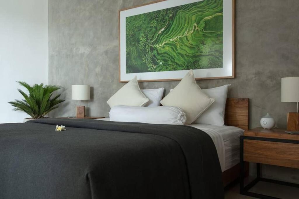 a bedroom with a large bed with white pillows at KARMA room in Villa ABSOLUTE Shared Villa in Canggu