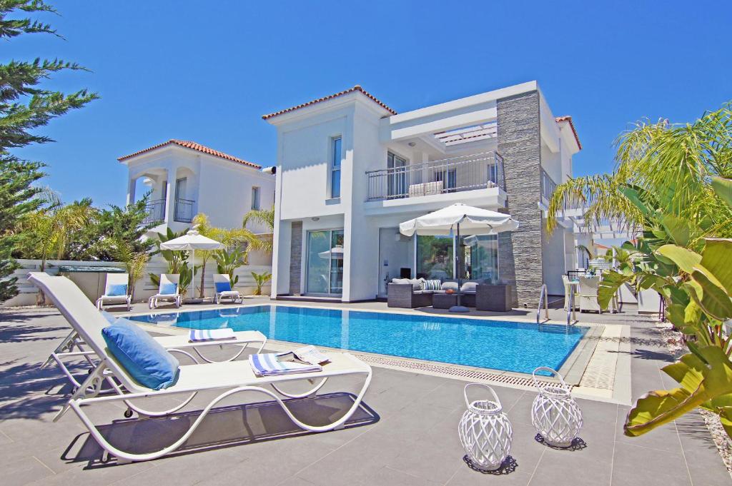 uma villa com uma piscina e uma casa em Villa Solebianco Protaras em Protaras