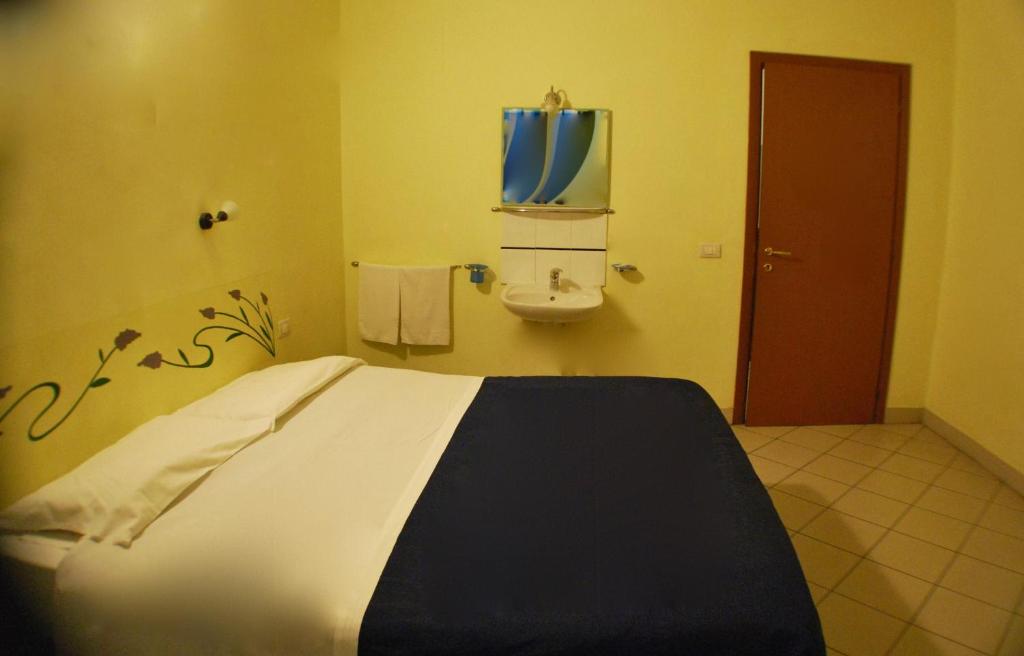 Postel nebo postele na pokoji v ubytování AlbergoTeatro