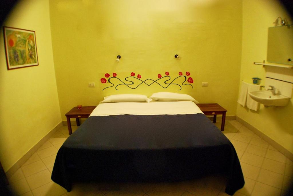 Postel nebo postele na pokoji v ubytování AlbergoTeatro
