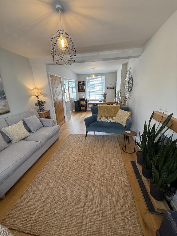 a living room with a couch and a table at Highfield Terrace – Cosy Devon Retreat, Close to Beer Beach in Beer