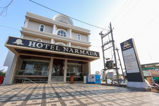 a hotel karambadi with a sign in front of it at HOTEL NARMADA RESIDENCY in Maheshwar