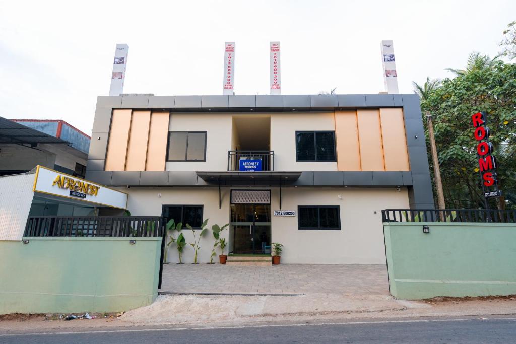 a building with a sign on the front of it at Hotel Aeronest Residency in Calicut