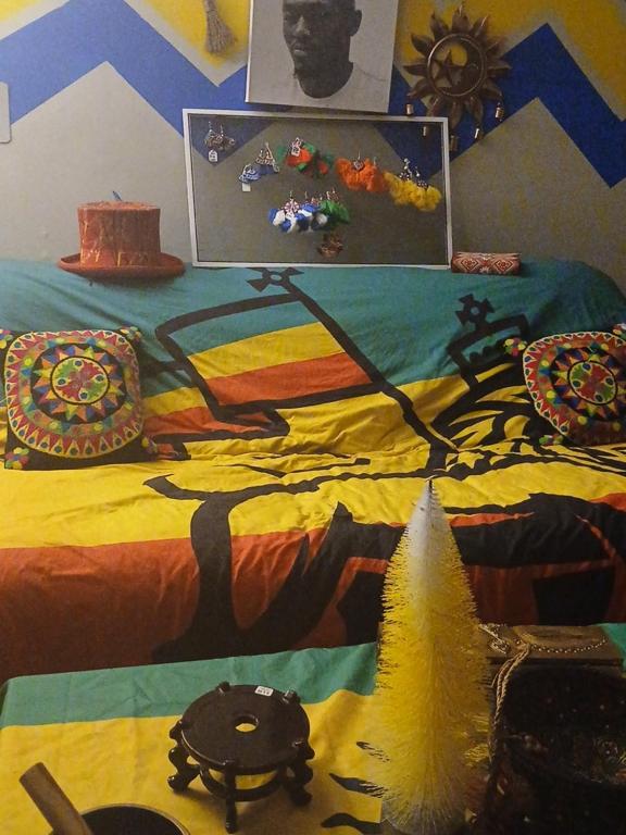 a bed with a painting of a tree on it at Rasta House Fantasy in Lithia Springs