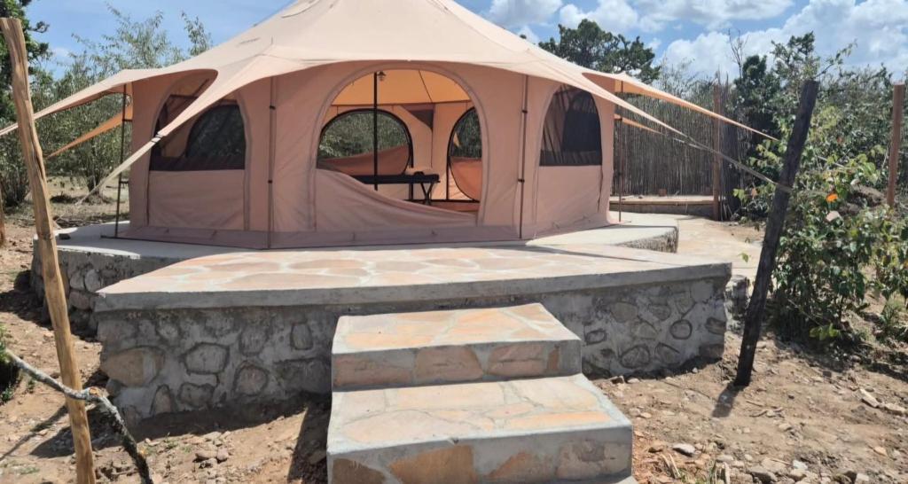 a small tent with a table in a field at Bwana Renman Campsite in Narok
