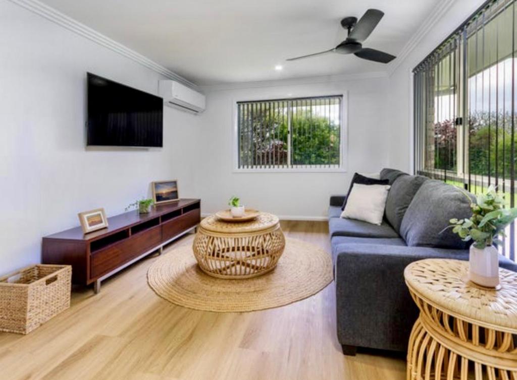 a living room with a couch and a table at House 4-bed 2-bath Caboolture South in Caboolture