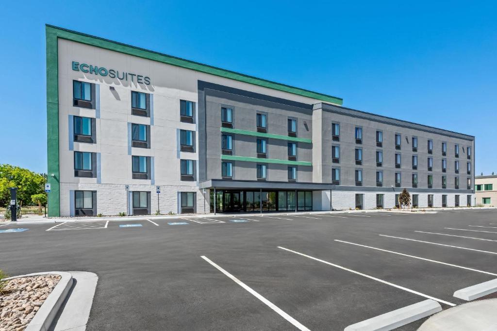 an empty parking lot in front of a building at ECHO Suites Extended Stay by Wyndham Reno in Reno