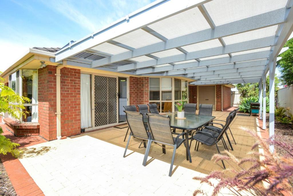 a patio with a table and chairs on it at 2 Marto Court in Normanville