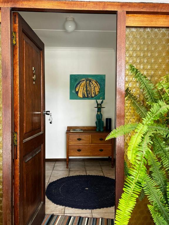 an open door to a room with a wooden table at Casa Bella in Dwarskersbos