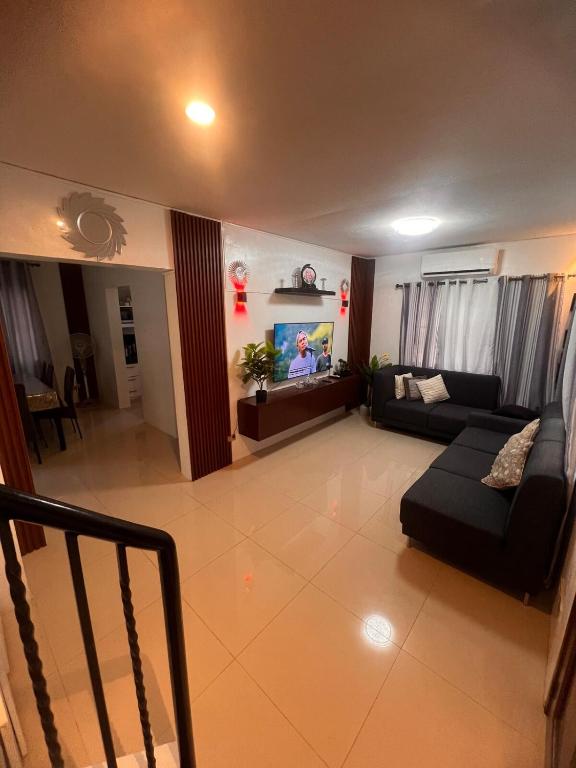 a living room with a couch and a tv at 2-Storey with 4BR Villa in a High-End Subdivision in Davao City