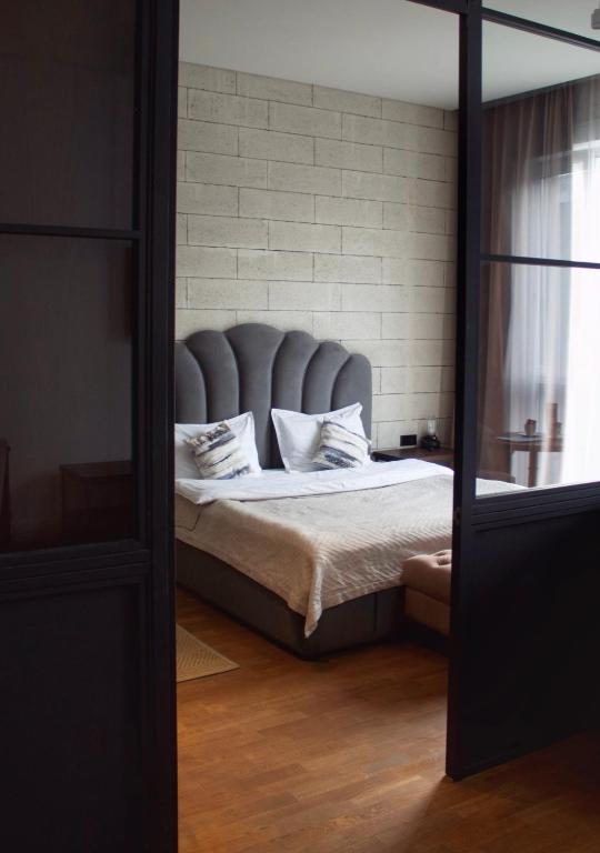 a bedroom with a bed with a blue headboard at ЖК Esentai city in Almaty
