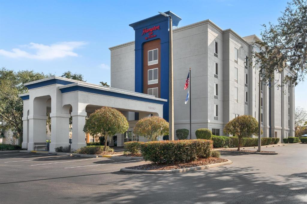 a hotel building with a flag in front of it at Hampton Inn Leesburg Tavares in Leesburg