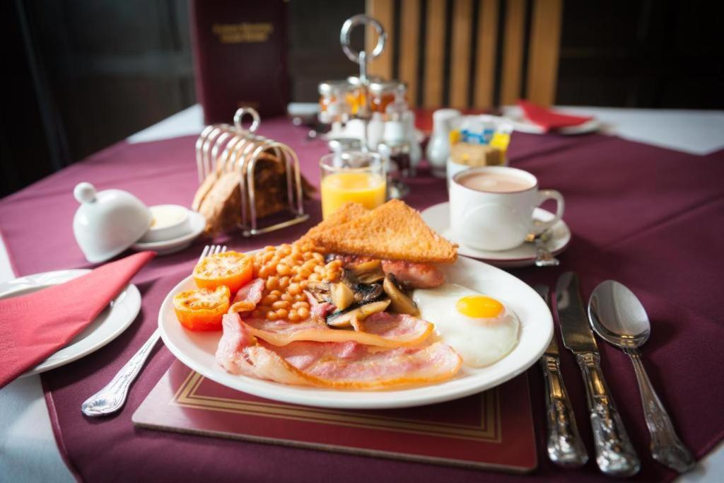 a plate of breakfast food on a table at Potters Mooring Guest House in Teignmouth