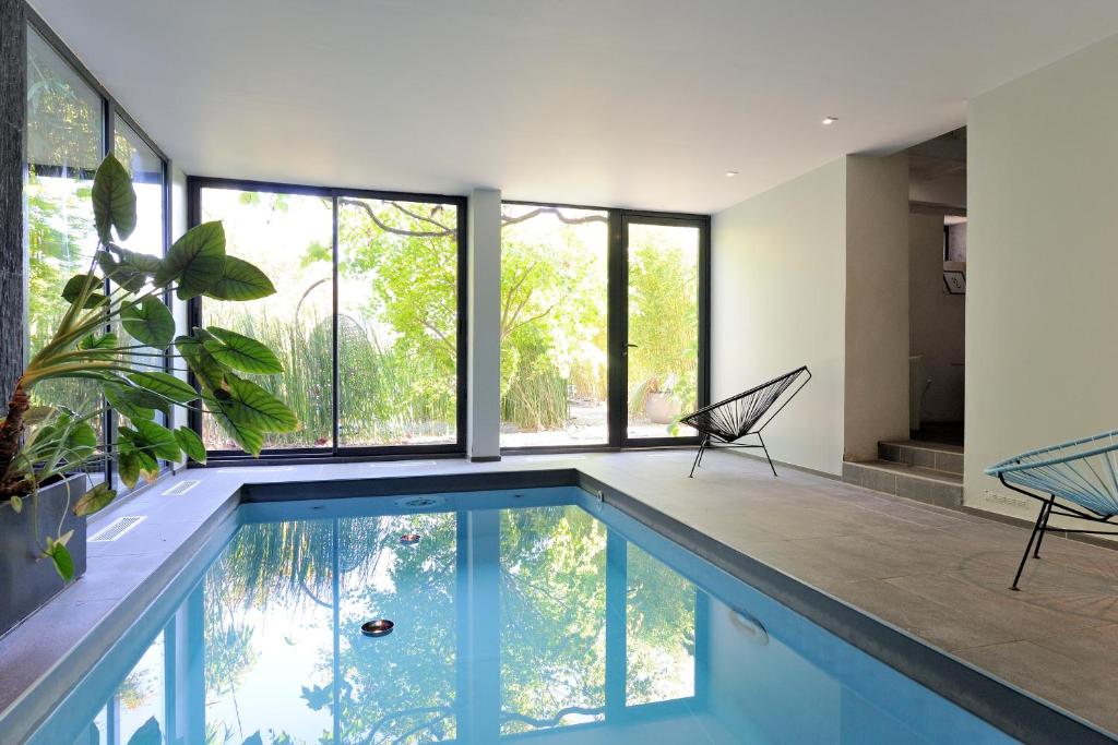 a swimming pool in a house with a large window at Ty Mad in Douarnenez