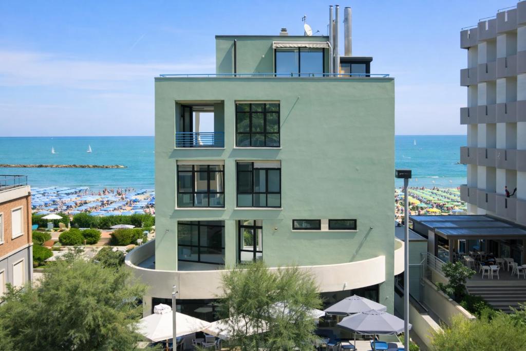 a building with the ocean in the background at AMA Marena Apartments in Pesaro