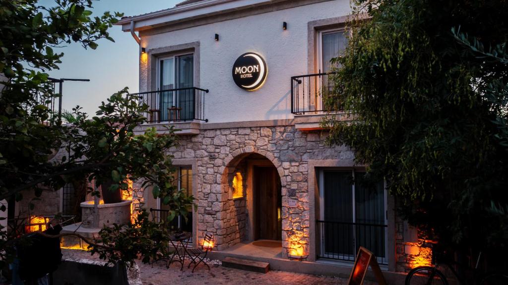 a building with a sign on the side of it at Moon Alaçatı adults only in Çeşme