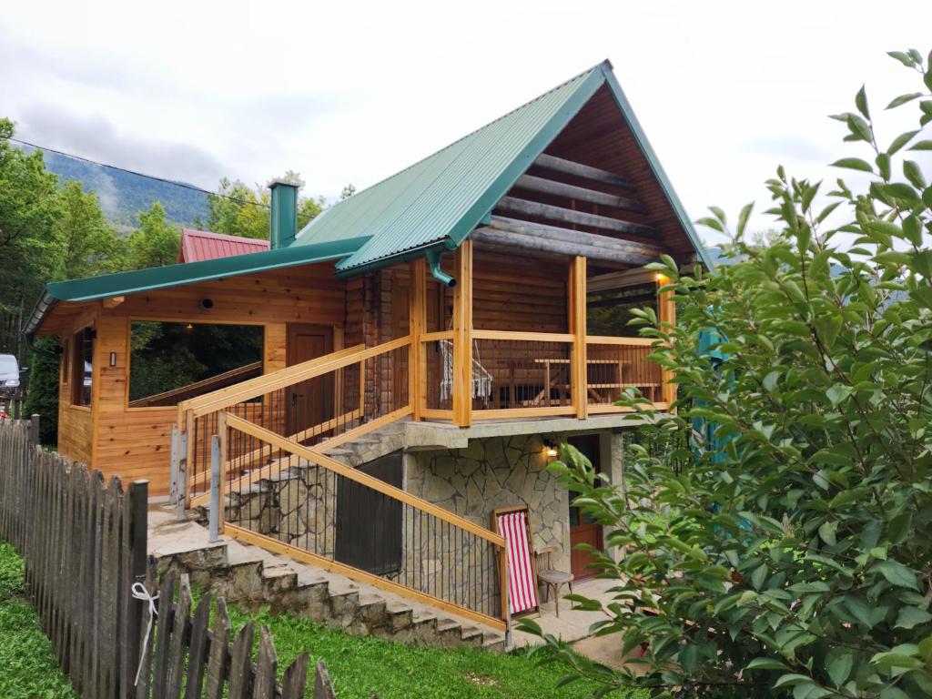 a log cabin with a porch and a deck at Honeywood Cabin I with Private Spa in Bijelo Polje