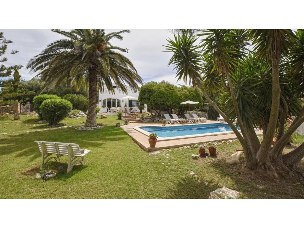 a house with a pool and a palm tree at Alaior Villa with Private Pool in Alaior