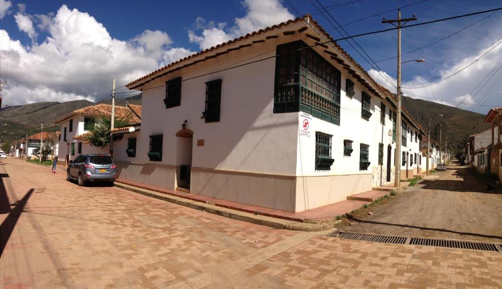 a car parked in front of a building on a street at Casa Villa de Leyva in Villa de Leyva