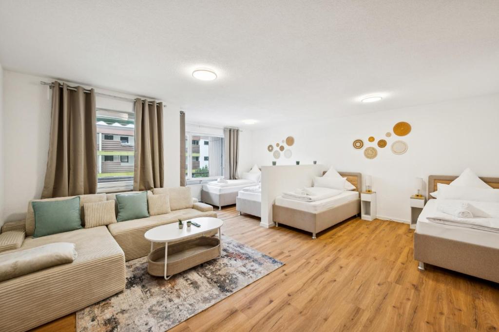 a living room with a couch and a table at Ramoni Apartments - Abendgold in Enzklösterle