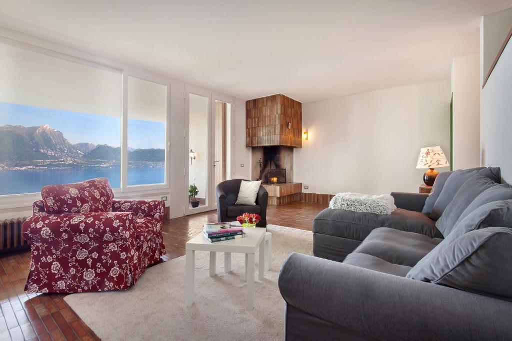 a living room with a couch and chairs and a fireplace at Villa Brancolino - Fine Living in Garda