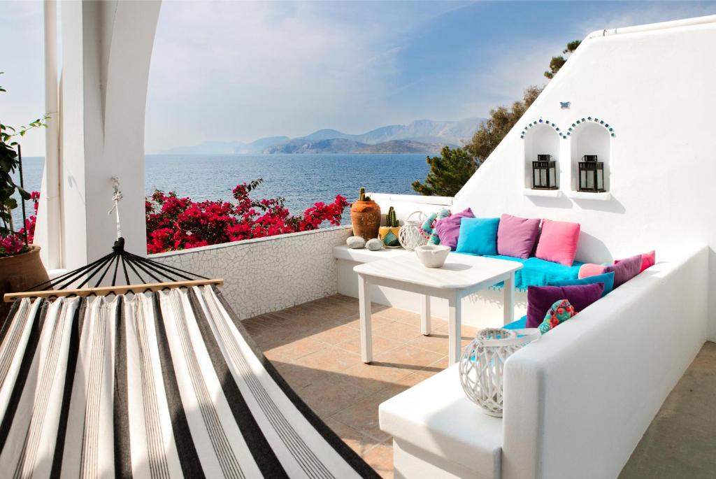 a balcony with a view of the ocean on a house at Seafront Casa Azul Villa - Getaway in Kalymnos in Kalymnos