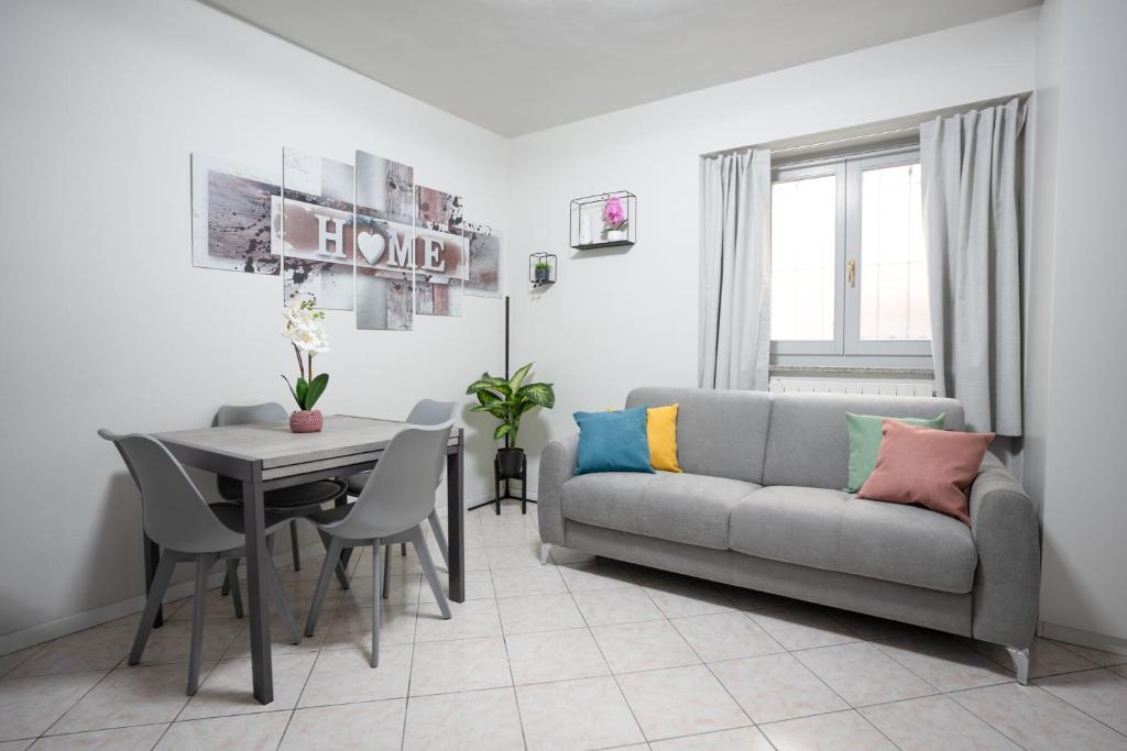 a living room with a couch and a table at Antonella's sweet home AIRPORT ORIO AL SERIO in Stezzano