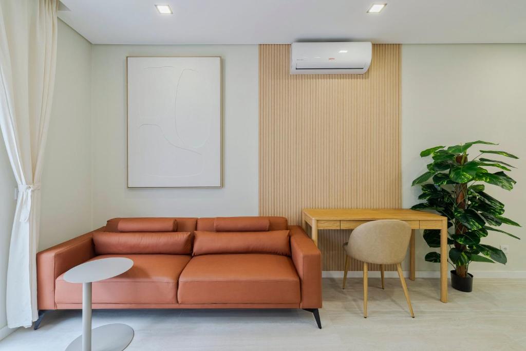 a living room with a couch and a table at Setúbal Serenity Villa II, By Home Match in Setúbal