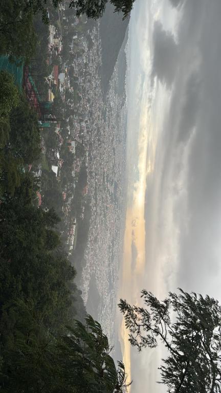 a view of a waterfall from the side of a mountain at Perched on a mountain top, breathtaking city view in Kathmandu