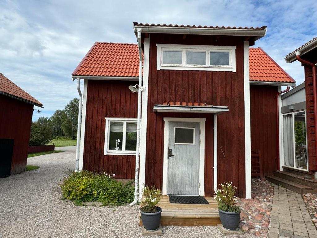 a red house with a white door and windows at Dalagård i Insjön in Insjön