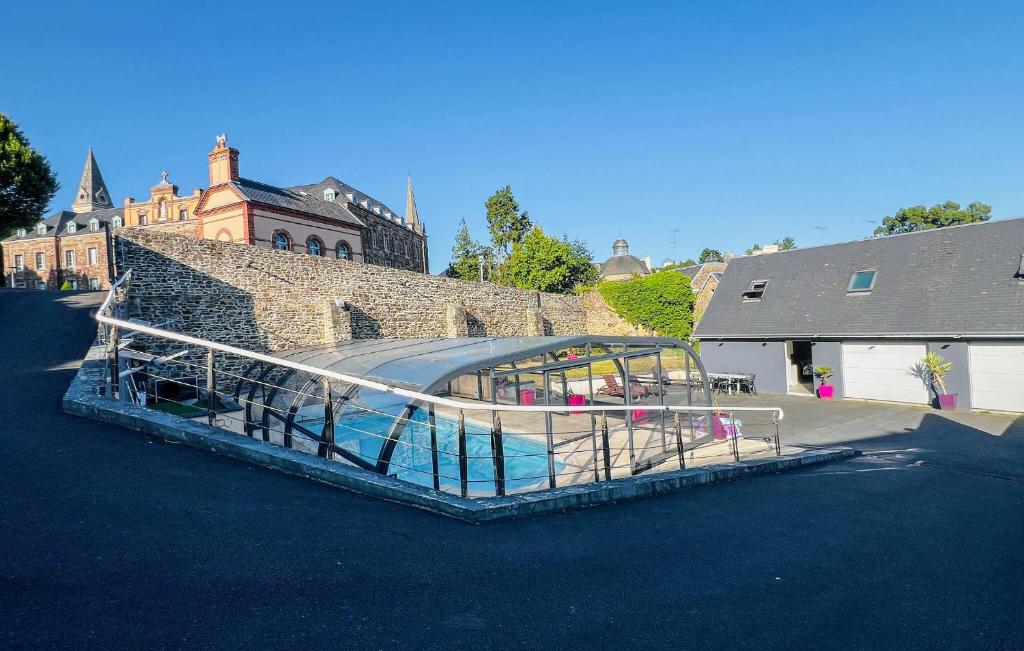 a building with a swimming pool in front of a building at Maison Avec Piscine in Coutances