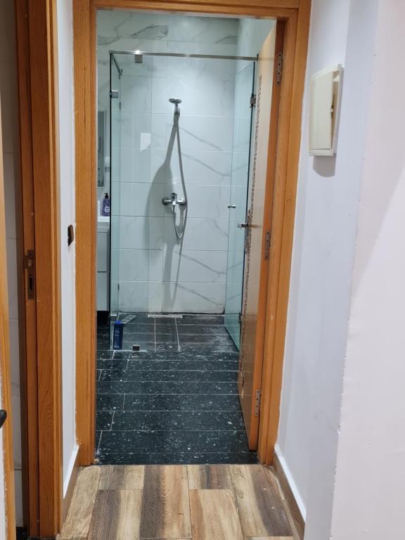 a glass shower door in a bathroom with a toilet at Adnani in Temara