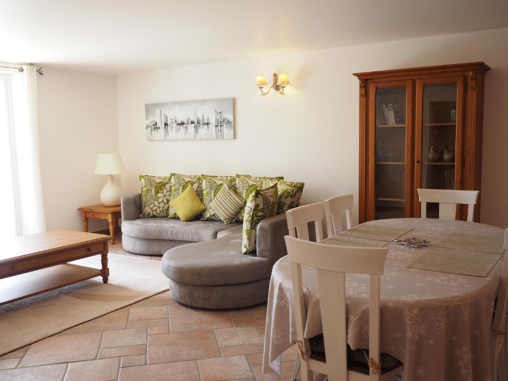 a living room with a table and a couch at campagne de pimayon in Manosque