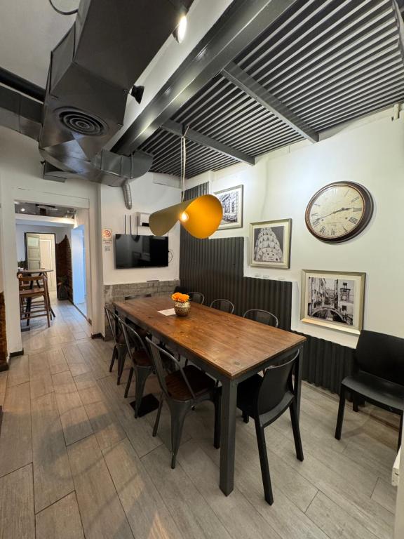 a dining room with a wooden table and chairs at PH Palermo HollyHouse in Buenos Aires