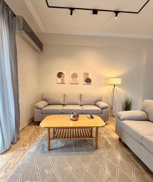 a living room with a couch and a coffee table at B2 Pausilipon Park Corner in Karditsa