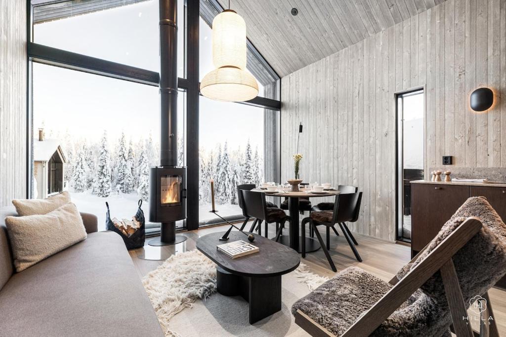 a living room with a couch and a table at North Suite Eclipse 15A by Hilla Villas in Kittilä