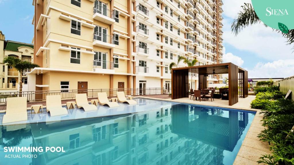 a swimming pool in front of a building at Gradient Sky in Manila