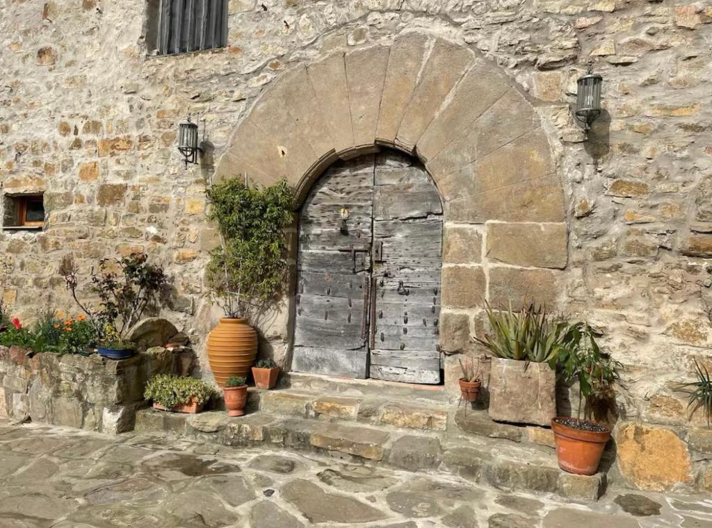 an entrance to a stone building with a door at Mas Costa in Sant Ferriol
