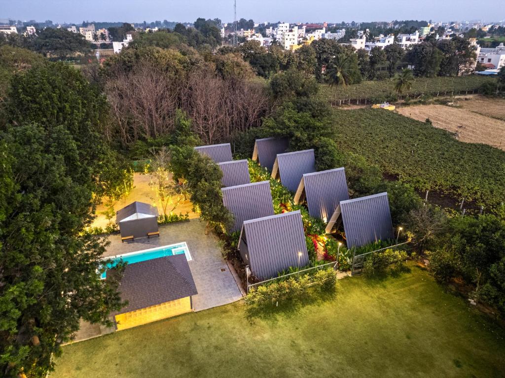 an overhead view of a house with a swimming pool at Alaya stays Inara Retreat 1-Cottage with a Mezzanine Loft, Shared Pool, and Garden in Bangalore