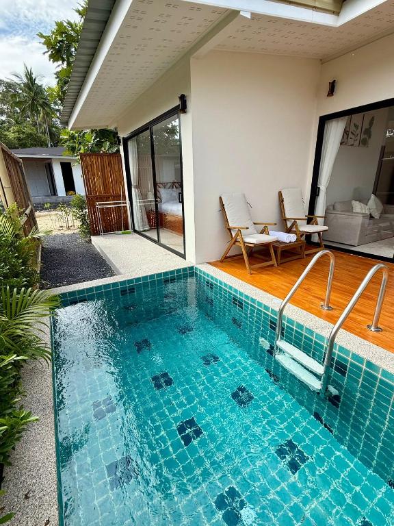 a swimming pool in front of a house at Srithanu Escape 1 in Srithanu